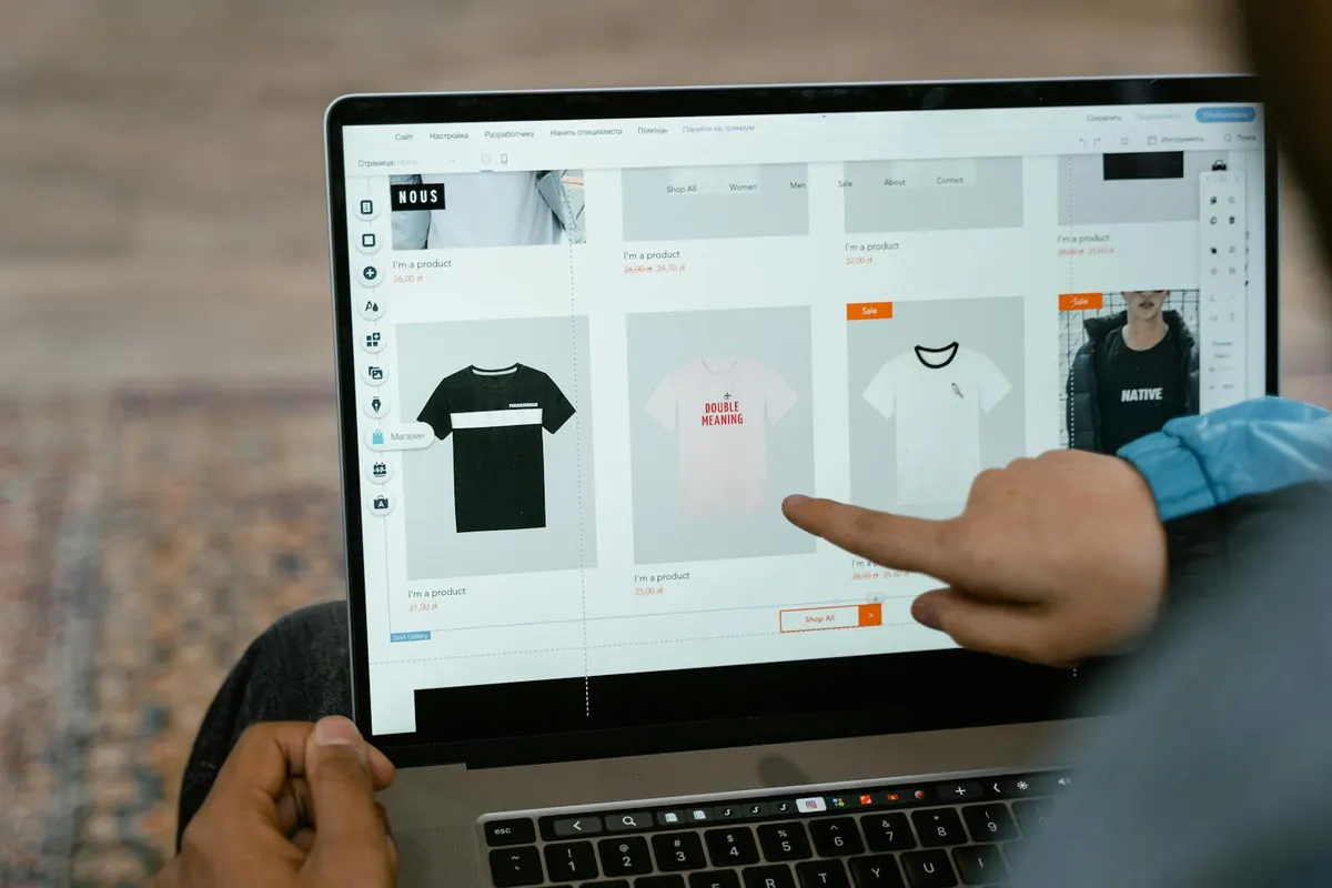 A professional reviewing multiple ecommerce dashboards on a laptop.